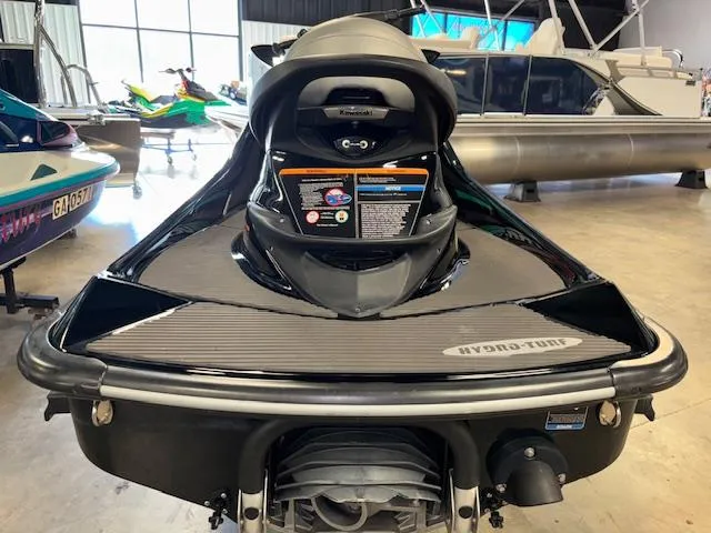 Slide: The Image of 2021 Kawasaki Ultra LX jet ski in showroom, rear view, black color, displayed indoors. - 6