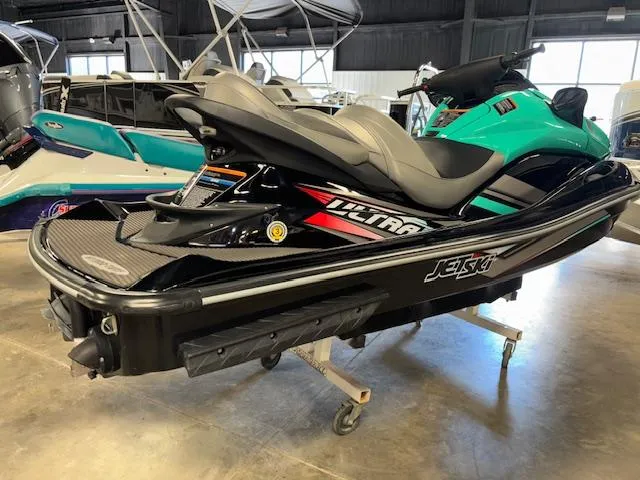 Slide: The Image of 2021 Kawasaki Ultra LX Jet Ski in showroom, black and teal design. - 8