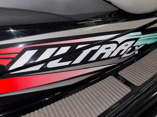 Slide: The Image of 2021 Kawasaki Ultra LX logo on a sleek black surface with colorful accents. - 9