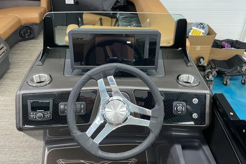 Slide: The Image of 2025 Bennington 22 M CRUISE boat dashboard with steering wheel and control panel. - 3