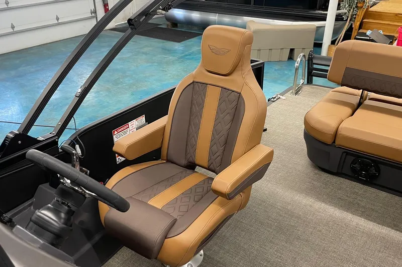 Slide: The Image of 2025 Bennington 22 M CRUISE boat interior with luxurious tan seating and steering wheel. - 4