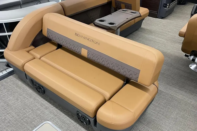 Slide: The Image of 2025 Bennington 22 M CRUISE boat interior with tan seating and cup holders. - 6