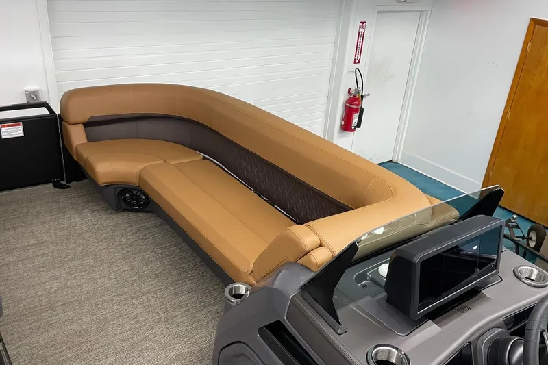 Slide: The Image of 2025 Bennington 22 M CRUISE boat interior with tan seating and modern dashboard. - 8