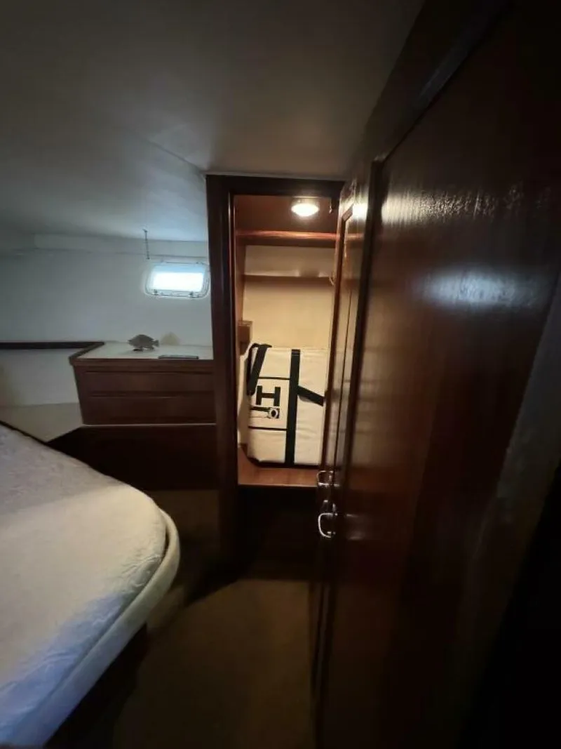 Slide: The Image of Interior cabin of 1989 Hatteras 42 Convertible yacht with bed and storage. - 10