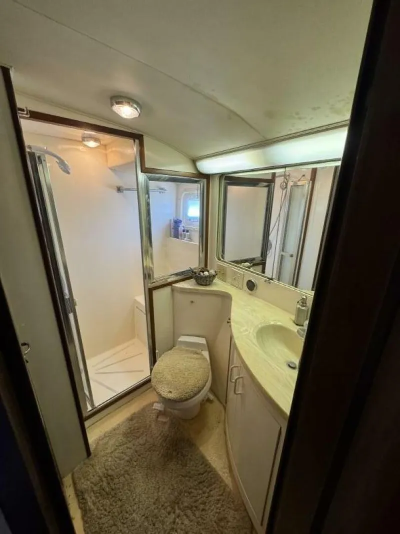 Slide: The Image of Bathroom interior of 1989 Hatteras 42 Convertible yacht, featuring shower and vanity. - 11