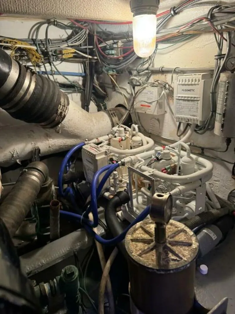 Slide: The Image of Engine room of 1989 Hatteras 42 Convertible with wiring and mechanical components. - 14