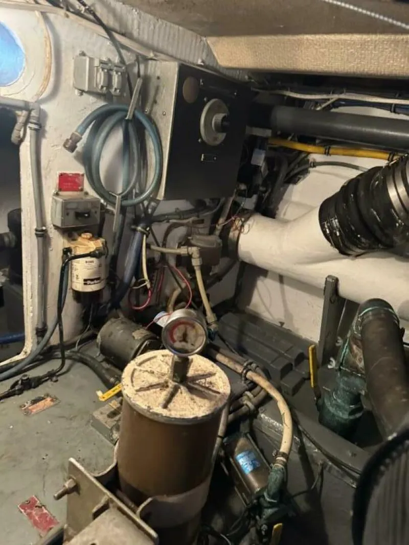 Slide: The Image of Engine room of 1989 Hatteras 42 Convertible boat with various mechanical components. - 15