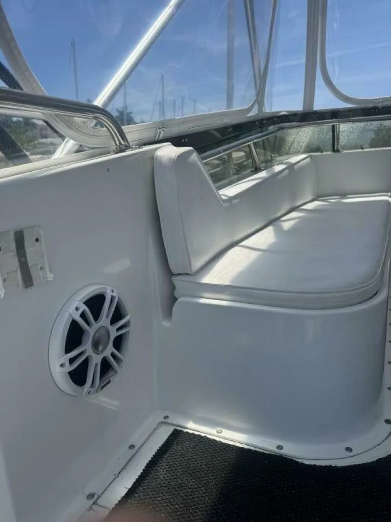 Slide: The Image of Interior of 1989 Hatteras 42 Convertible yacht with white seating and speaker. - 16