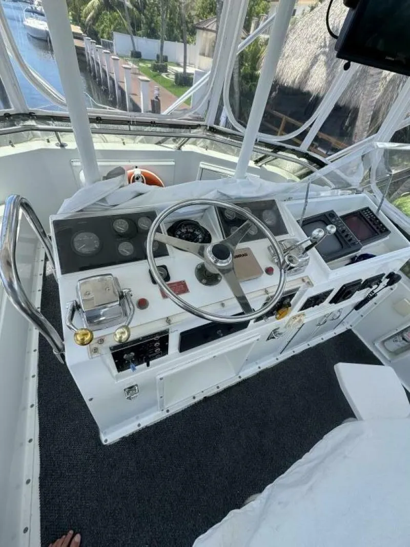 Slide: The Image of Cockpit of 1989 Hatteras 42 Convertible yacht with steering wheel and control panel. - 21
