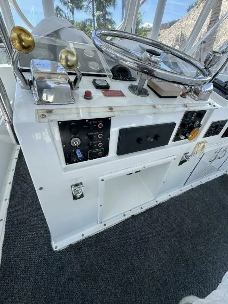 Slide: The Image of 1989 Hatteras 42 Convertible helm with steering wheel and control panel. - 22