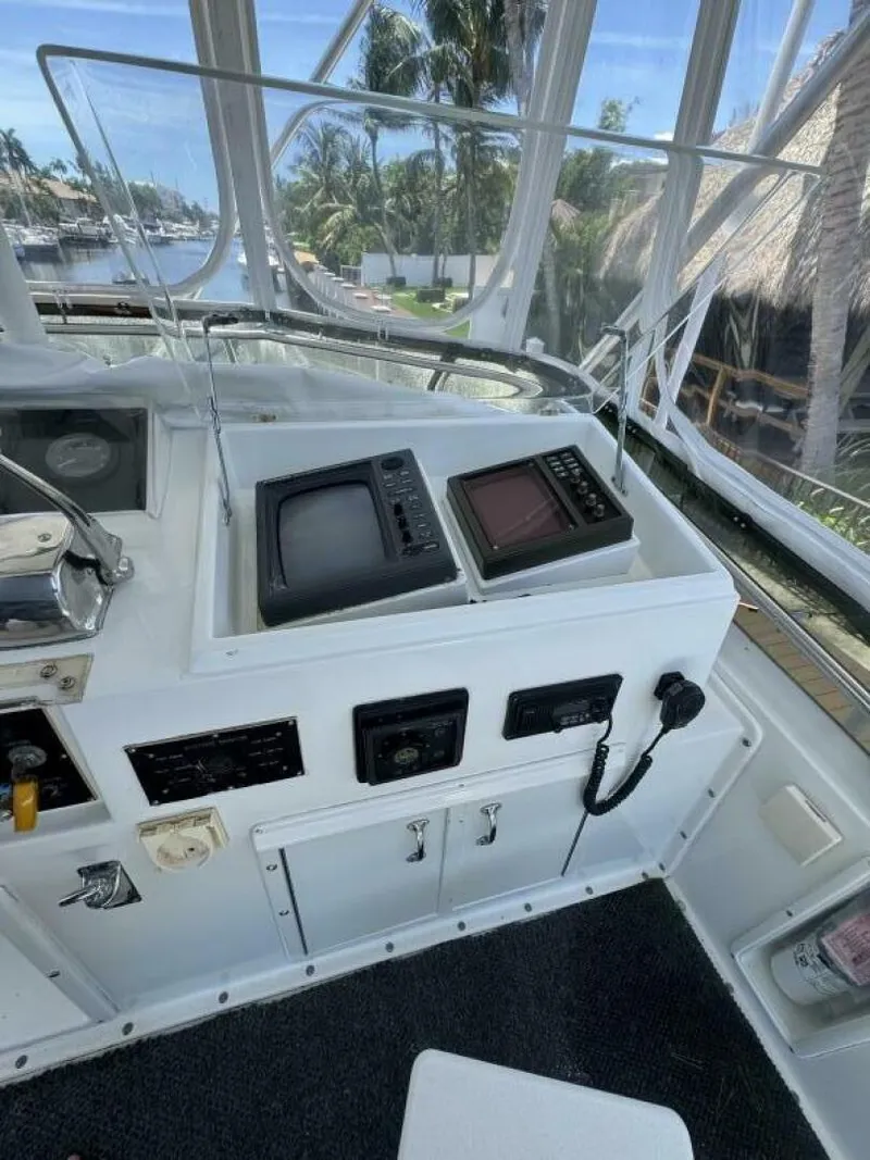 Slide: The Image of 1989 Hatteras 42 Convertible yacht cockpit with navigation equipment and ocean view. - 23