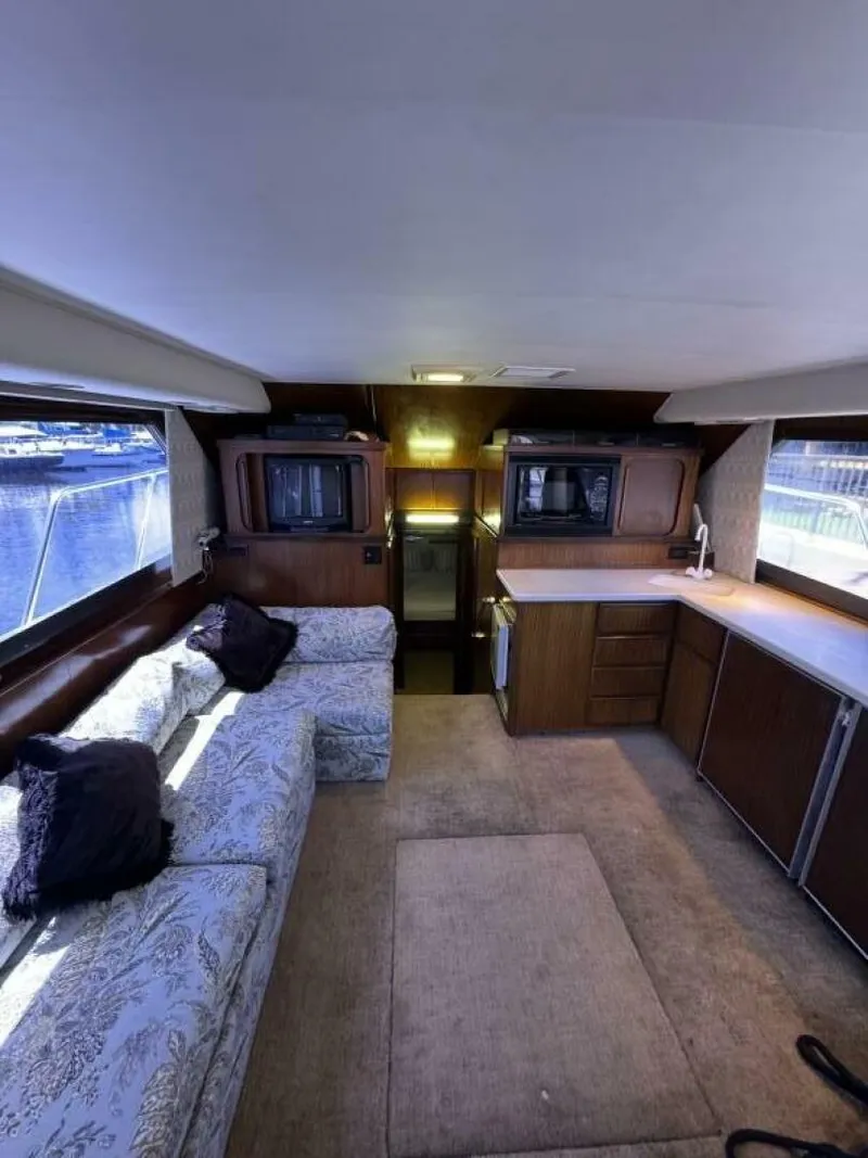 Slide: The Image of Interior of 1989 Hatteras 42 Convertible yacht with cozy seating and kitchenette. - 6