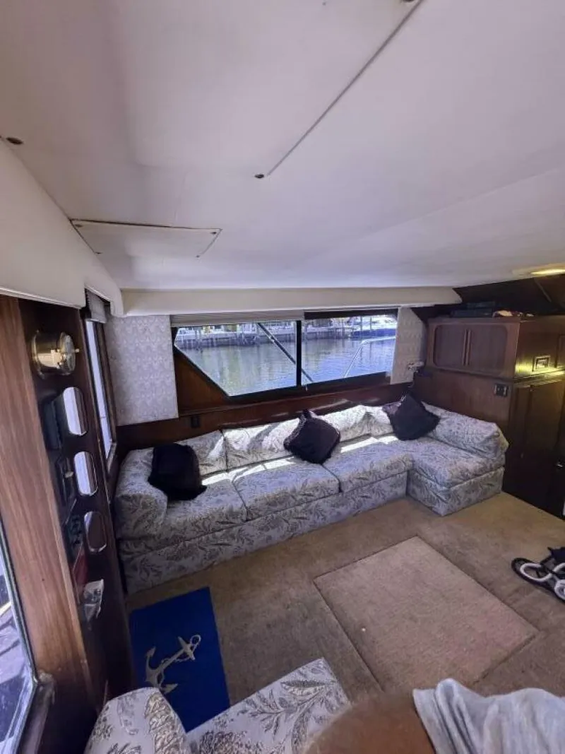 Slide: The Image of Interior of 1989 Hatteras 42 Convertible yacht with floral seating and large windows. - 7
