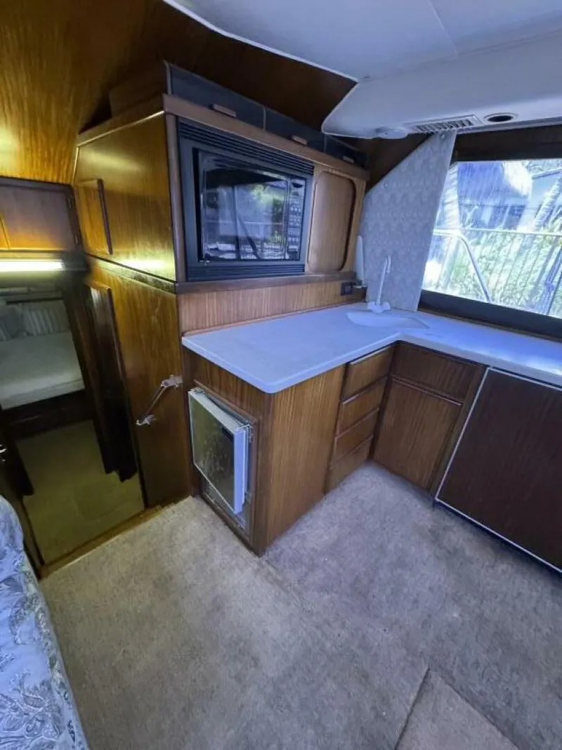 Slide: The Image of Interior of 1989 Hatteras 42 Convertible yacht with wood cabinetry and countertop. - 8