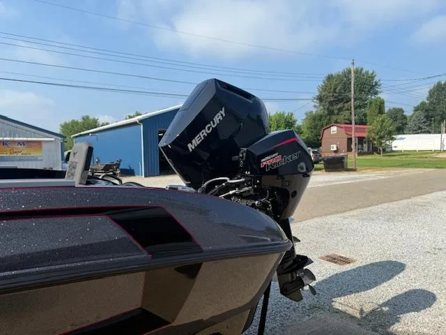 Slide: The Image of 2026 Vexus DVX22S boat with Mercury engine, parked outdoors on a sunny day. - 12