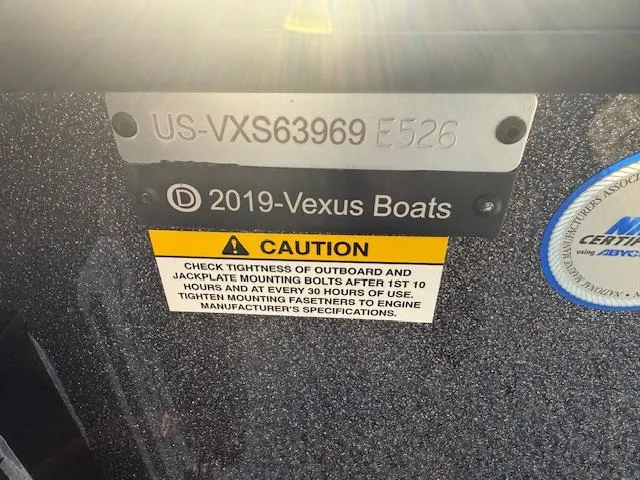 Slide: The Image of 2026 Vexus DVX22S boat identification plate with caution label and certification sticker. - 4