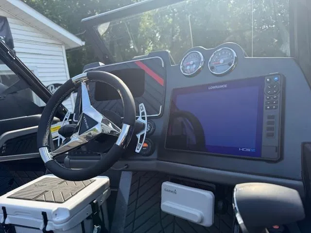 Slide: The Image of 2026 Vexus DVX22S boat dashboard with steering wheel, gauges, and Lowrance display. - 5