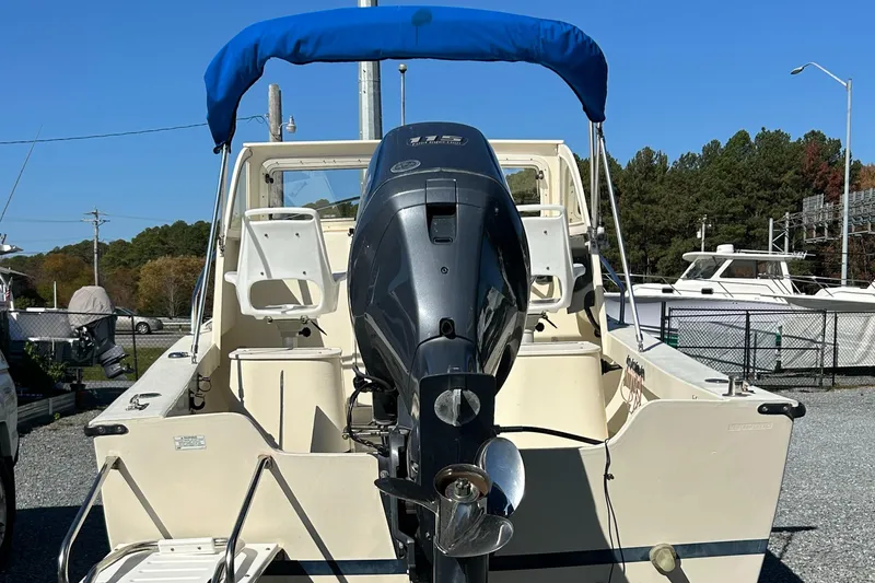 Slide: The Image of 2014 Seaway 21 Seafarer Cuddy boat with outboard motor and blue canopy. - 15