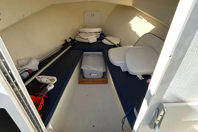 Slide: The Image of 2014 Seaway 21 Seafarer Cuddy cabin interior with cushions and storage items. - 18