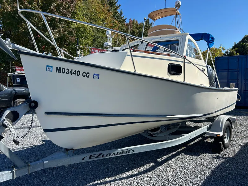 Slide: The Image of 2014 Seaway 21 Seafarer Cuddy boat on trailer, parked outdoors. - 2