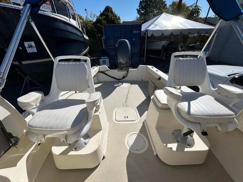 Slide: The Image of 2014 Seaway 21 Seafarer Cuddy boat interior with swivel seats and steering console. - 7