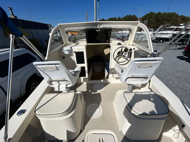 Slide: The Image of 2014 Seaway 21 Seafarer Cuddy boat interior with helm, seats, and storage compartments. - 8