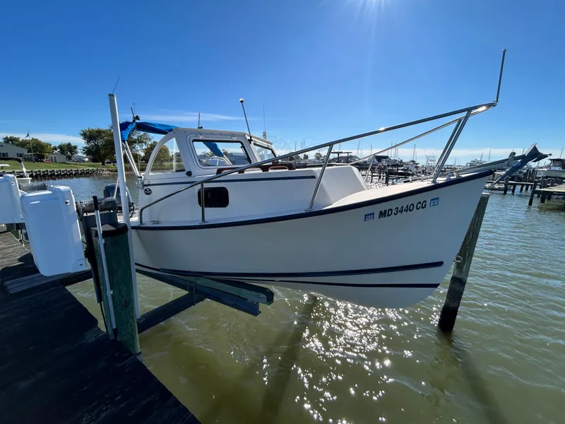 Slide: The Image of 2014 Seaway 21 Seafarer Cuddy boat docked on a sunny day. - 9