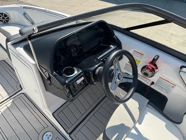 Slide: The Image of 2020 Yamaha Boats 195S dashboard with steering wheel and controls, featuring sleek design. - 13