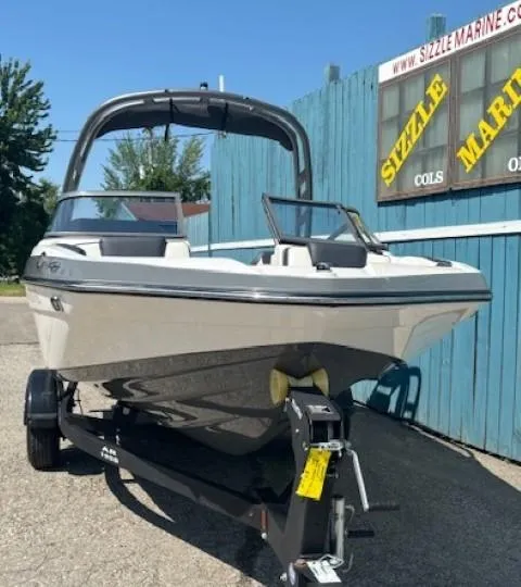 Slide: The Image of 2020 Yamaha Boats 195S on trailer, displayed outdoors near blue wooden fence. - 2