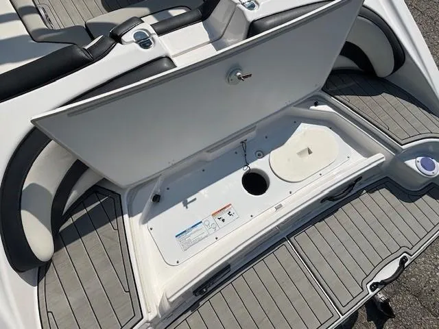 Slide: The Image of 2020 Yamaha Boats 195S storage compartment with open hatch, showcasing interior details. - 27