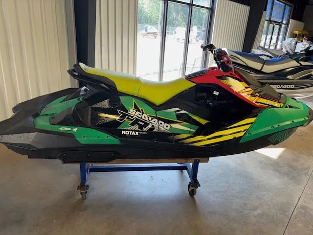 Slide: The Image of 2021 Sea-Doo SPARK TRIXX 3up jet ski in showroom, vibrant green and black design. - 4