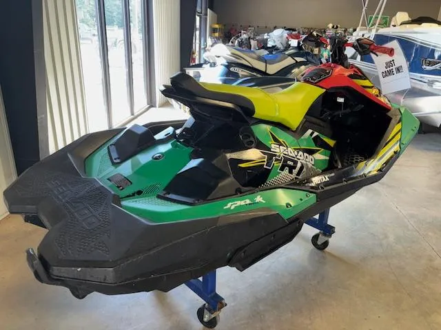 Slide: The Image of 2021 Sea-Doo SPARK TRIXX 3up jet ski in vibrant colors, displayed indoors. - 5