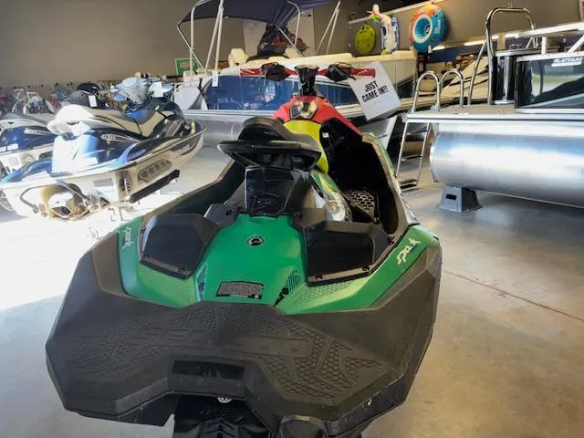 Slide: The Image of 2021 Sea-Doo SPARK TRIXX 3up jet ski in showroom with other watercraft. - 6