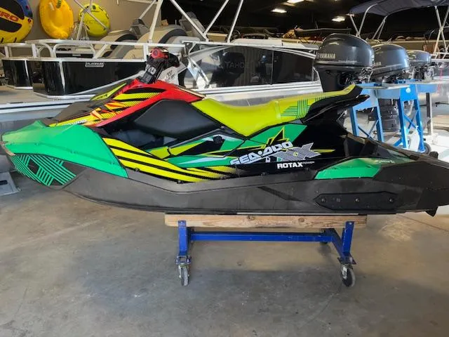 Slide: The Image of 2021 Sea-Doo SPARK TRIXX 3up jet ski in vibrant colors, displayed indoors. - 8