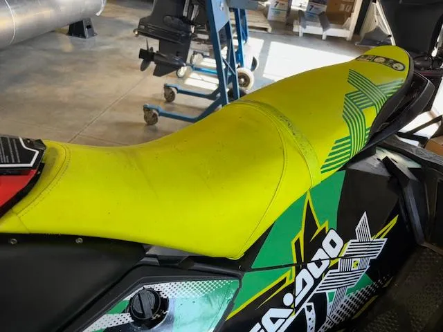 Slide: The Image of 2021 Sea-Doo SPARK TRIXX 3up with vibrant yellow seat in a garage setting. - 9