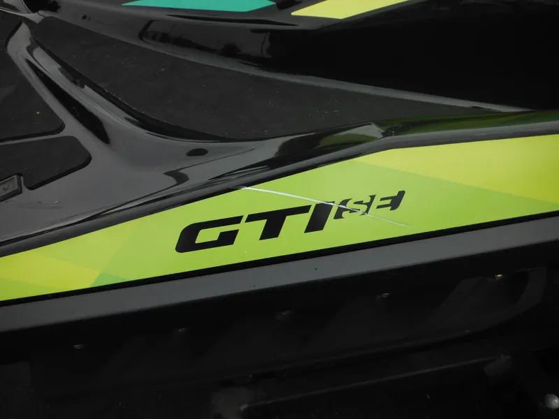 Slide: The Image of 2019 Sea-Doo GTI SE 155 jet ski with green and black design. - 12