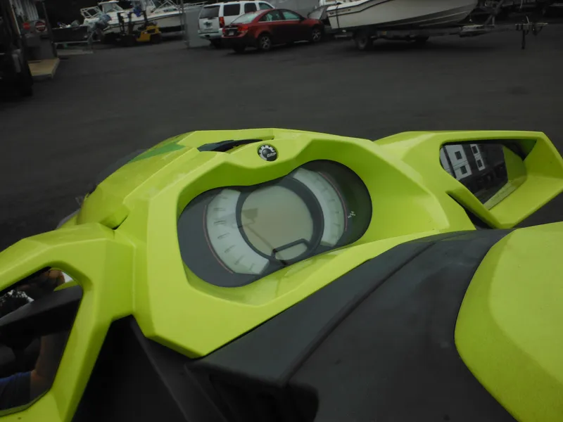 Slide: The Image of 2019 Sea-Doo GTI SE 155 dashboard, vibrant yellow, parked near boats and cars. - 18
