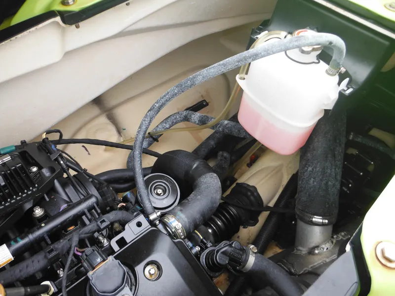 Slide: The Image of 2019 Sea-Doo GTI SE 155 engine compartment with visible components and coolant reservoir. - 26