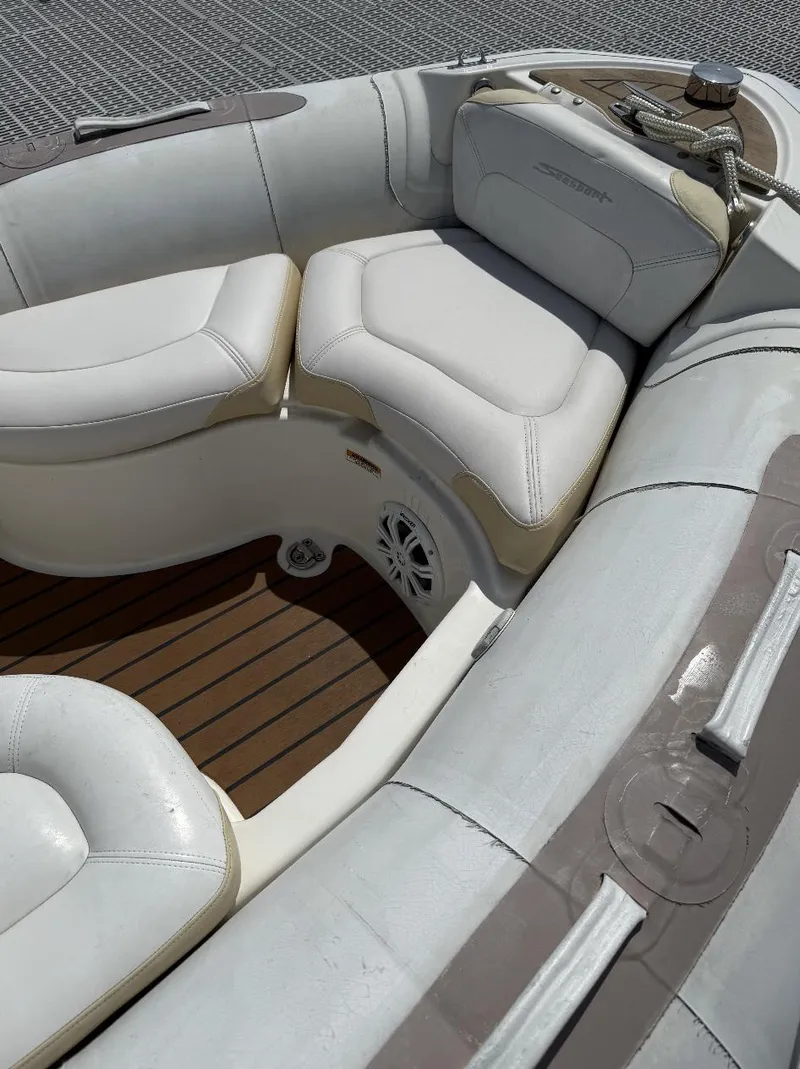 Slide: The Image of Interior of a 2018 Zodiac Avon boat with cushioned seating and wooden flooring. - 5