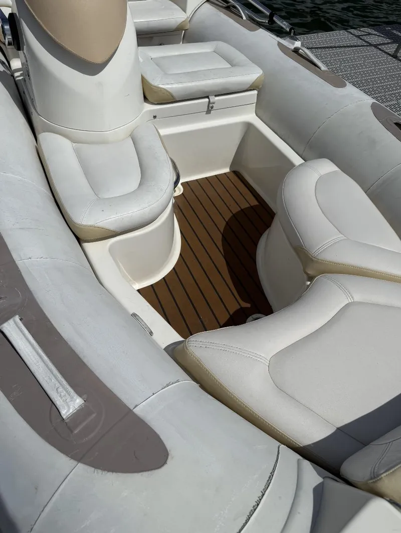 Slide: The Image of 2018 Zodiac Avon boat interior with white cushioned seats and wooden flooring. - 6