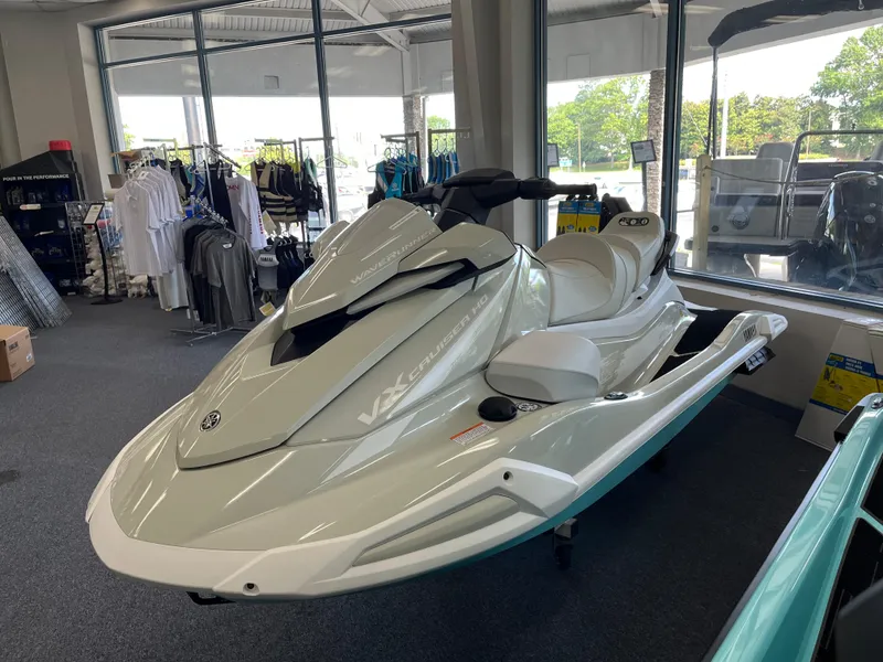 The Image of 2025 Yamaha WaveRunner VX Cruise HO displayed in showroom with apparel in background. - 0