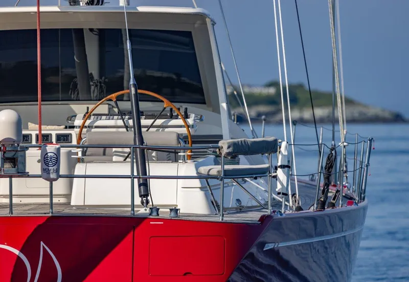 Slide: The Image of Nautor Swan 100 Pilothouse yacht, 2003 model, with red hull and elegant deck design. - 11