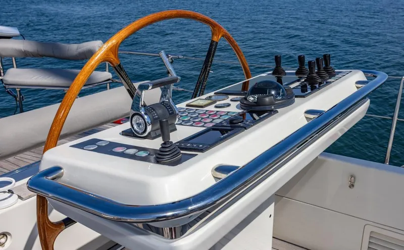 Slide: The Image of Pilothouse controls of 2003 Nautor Swan 100 yacht with ocean backdrop. - 17
