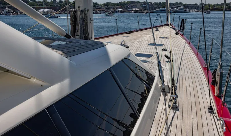 Slide: The Image of Deck view of 2003 Nautor Swan 100 Pilothouse yacht, showcasing sleek design and waterfront backdrop. - 20