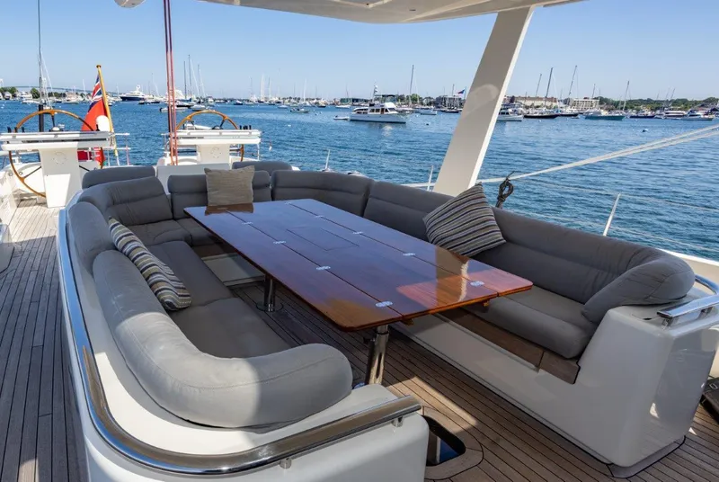 Slide: The Image of Luxurious deck seating on 2003 Nautor Swan 100 Pilothouse yacht, overlooking marina. - 23