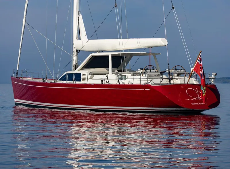 Slide: The Image of Red 2003 Nautor Swan 100 Pilothouse yacht on calm water, featuring sleek design and dual steering wheels. - 3