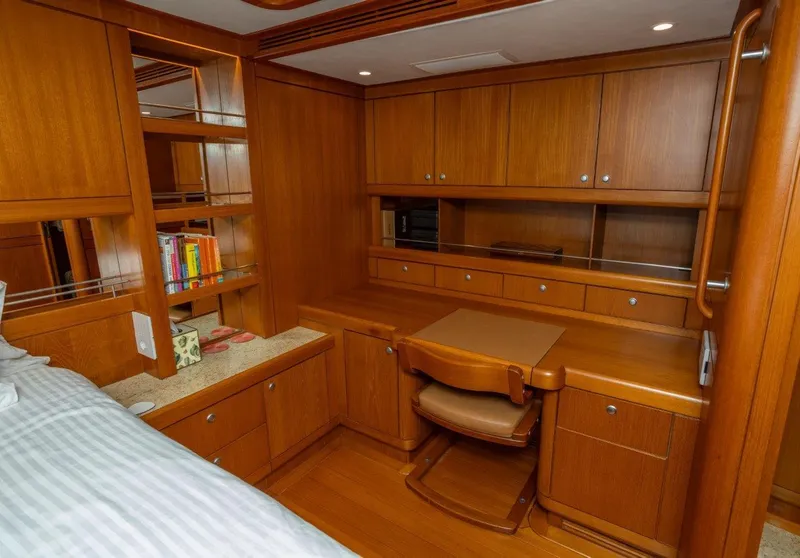 Slide: The Image of Luxurious wooden interior of 2003 Nautor Swan 100 Pilothouse yacht cabin with desk and shelves. - 41