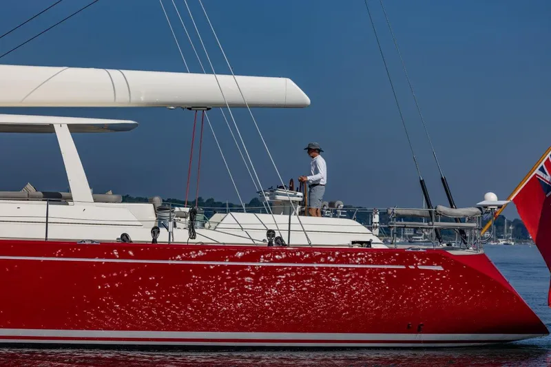 Slide: The Image of Red Nautor Swan 100 Pilothouse yacht sailing, 2003 model, with person on deck. - 5