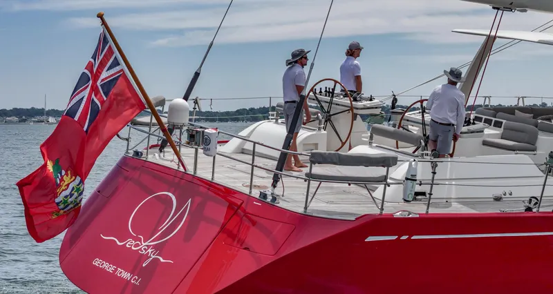 Slide: The Image of Sailing yacht Nautor Swan 100 Pilothouse, 2003, with crew on deck, red hull, British flag. - 6