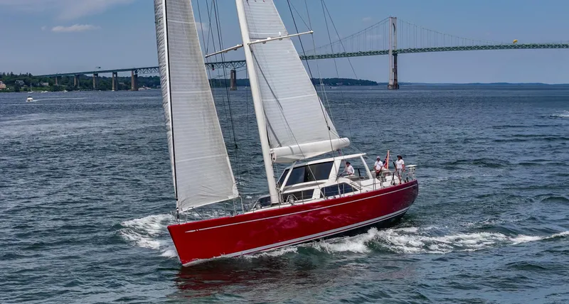 Slide: The Image of Red Nautor Swan 100 Pilothouse yacht sailing near a bridge, 2003 model. - 8